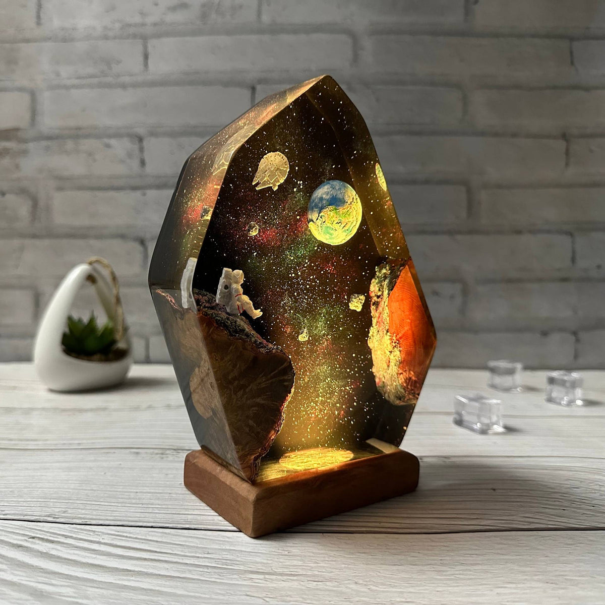 Earthrise Lamp — the Earth rising over a resin galaxy on a wood base, lit from below