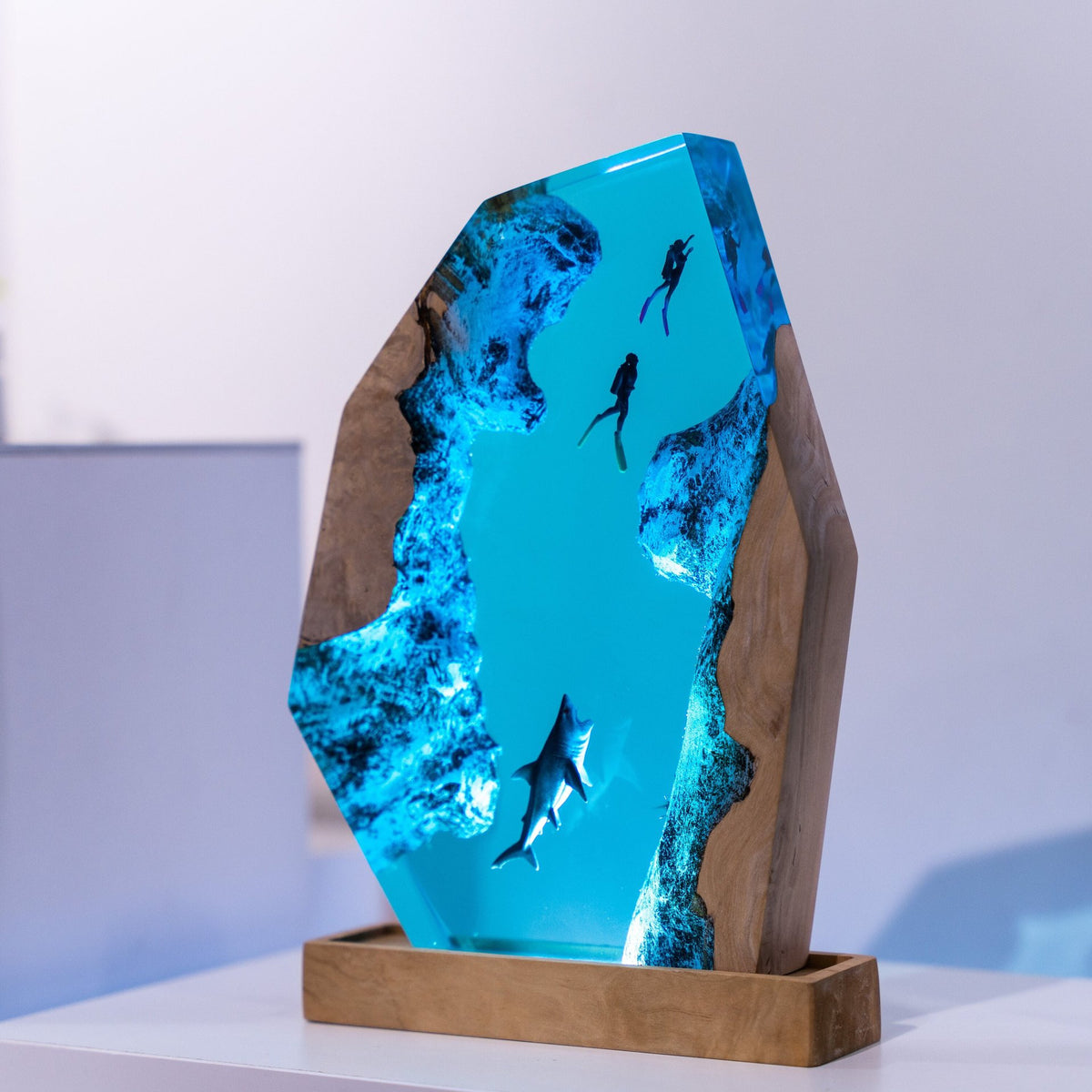 Diver Lamp — two divers and a shark in open blue water, cast in resin between two pieces of wood
