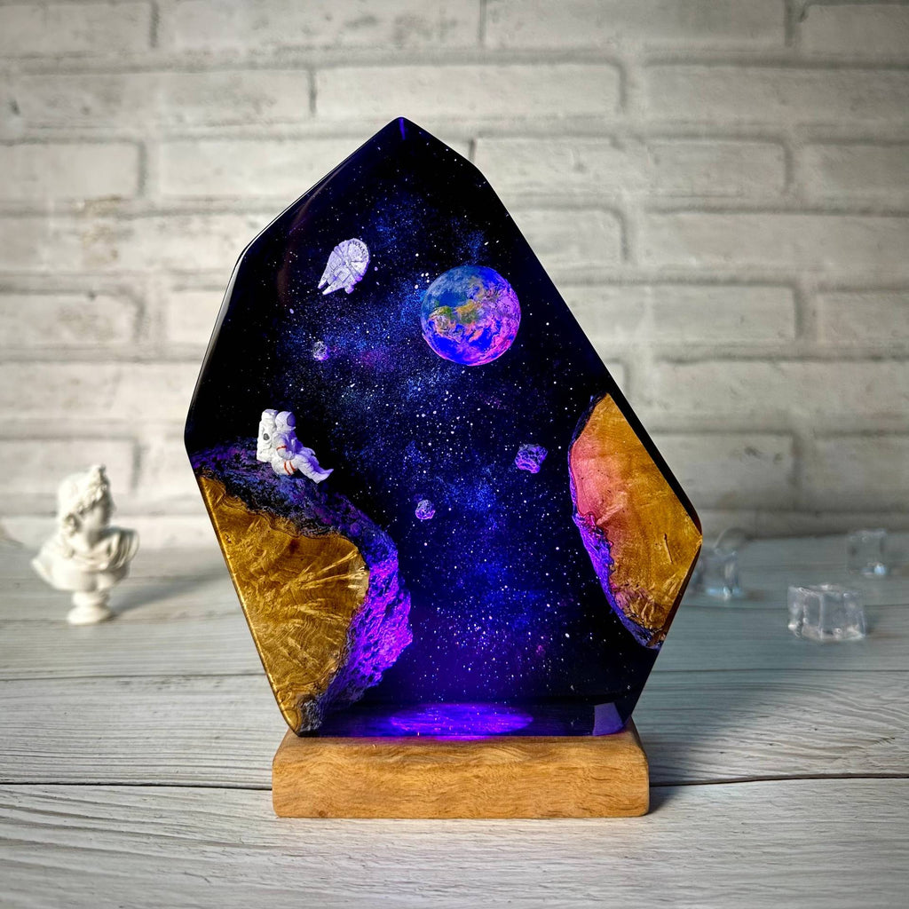 Earthrise Lamp — the Earth rising over a resin galaxy on a wood base, lit from below