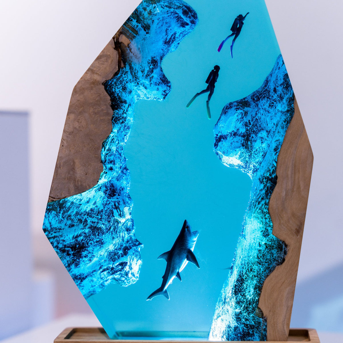 Diver Lamp — two divers and a shark in open blue water, cast in resin between two pieces of wood