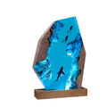 Diver Lamp — two divers and a shark in open blue water, cast in resin between two pieces of wood